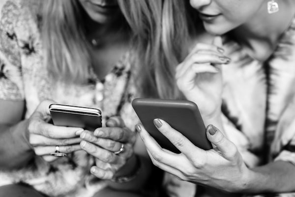 two women using cell phones