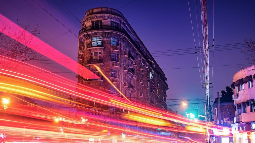 A night time lapse showing blurred lights, depicting the feeling of moving fast.